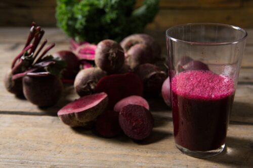 Beetroot and beetroot juice on wooden table