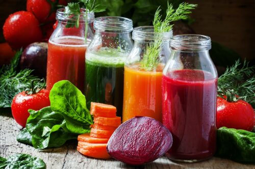 Four kind of vegetable juices: red, burgundy, orange, green